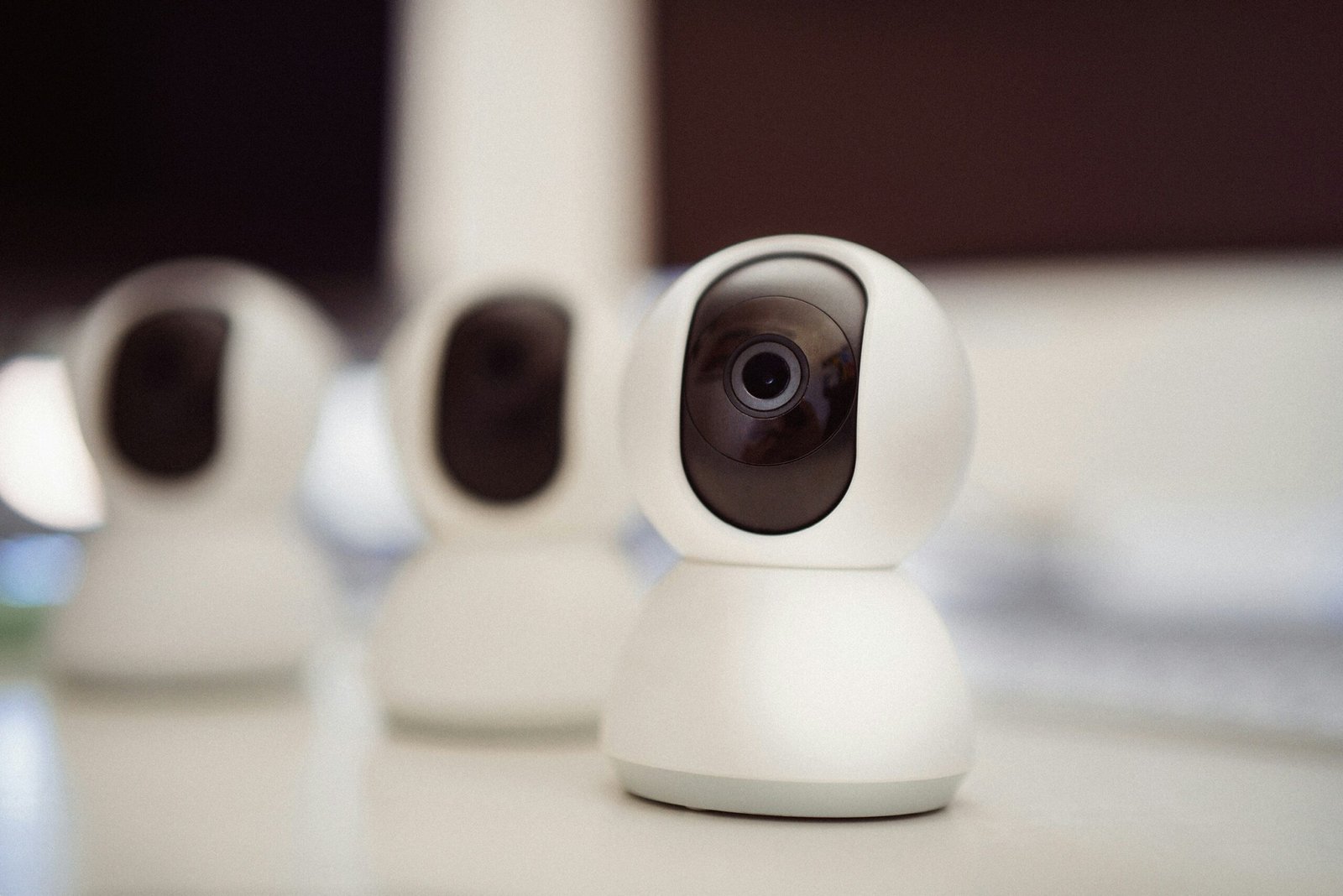 Image of multiple smart cameras displayed on a table, showcasing their sleek design and advanced features for home security and monitoring.