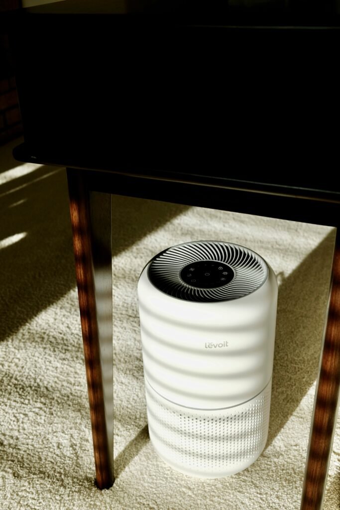 Smart air purifier in a modern living room, designed to improve indoor air quality by removing dust, allergens, and odors, with a sleek and compact design.